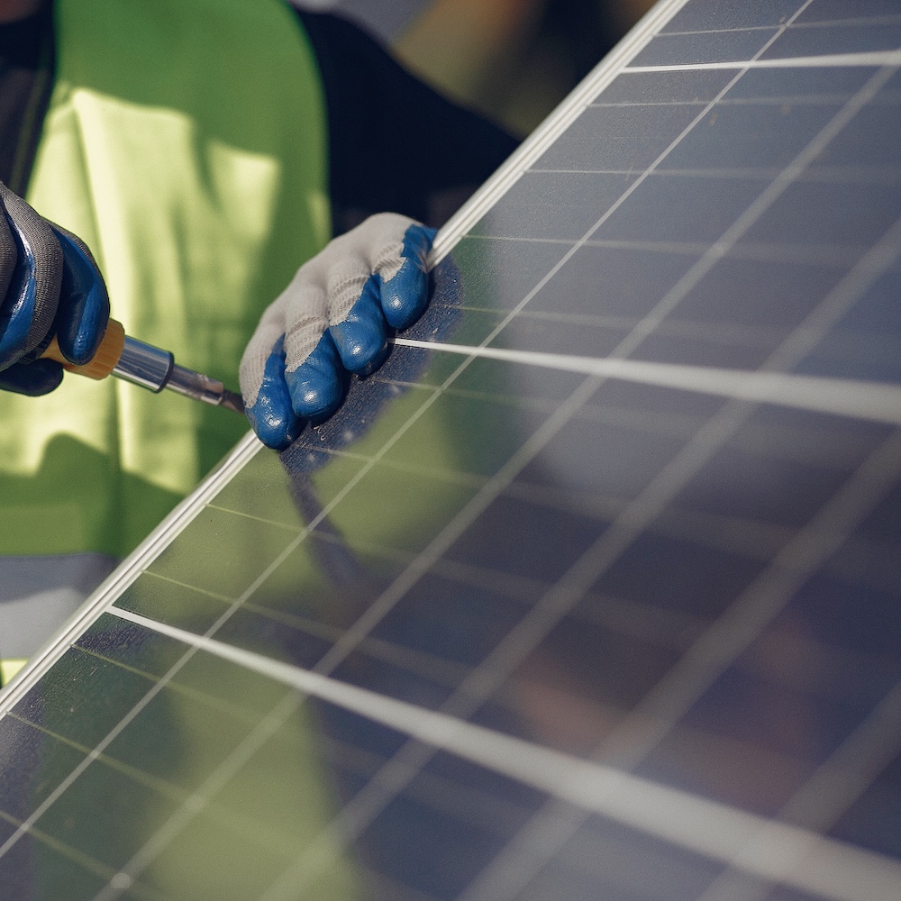 Man working on ground mounted solar panels